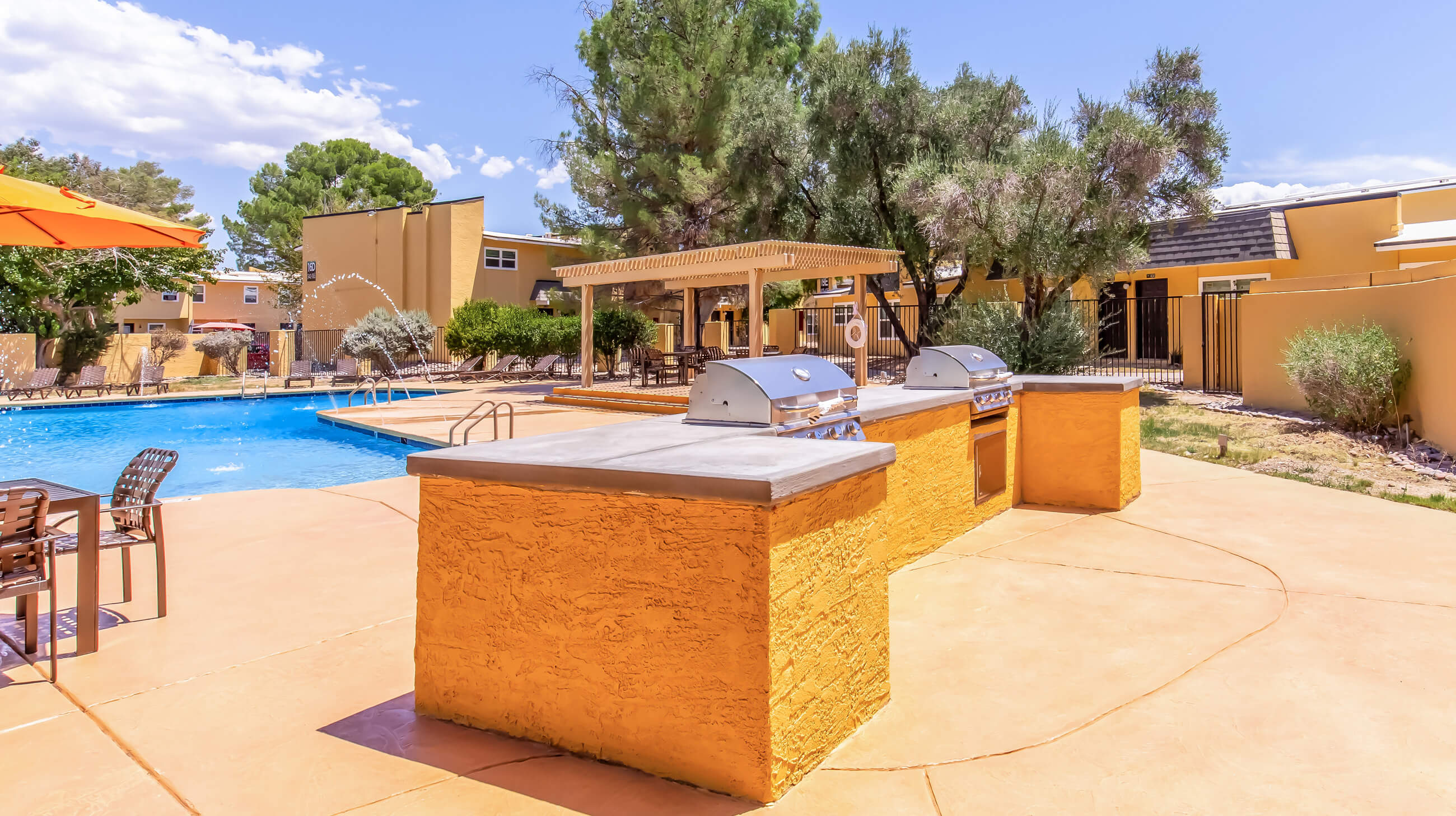 Apartment pool with lounge chairs