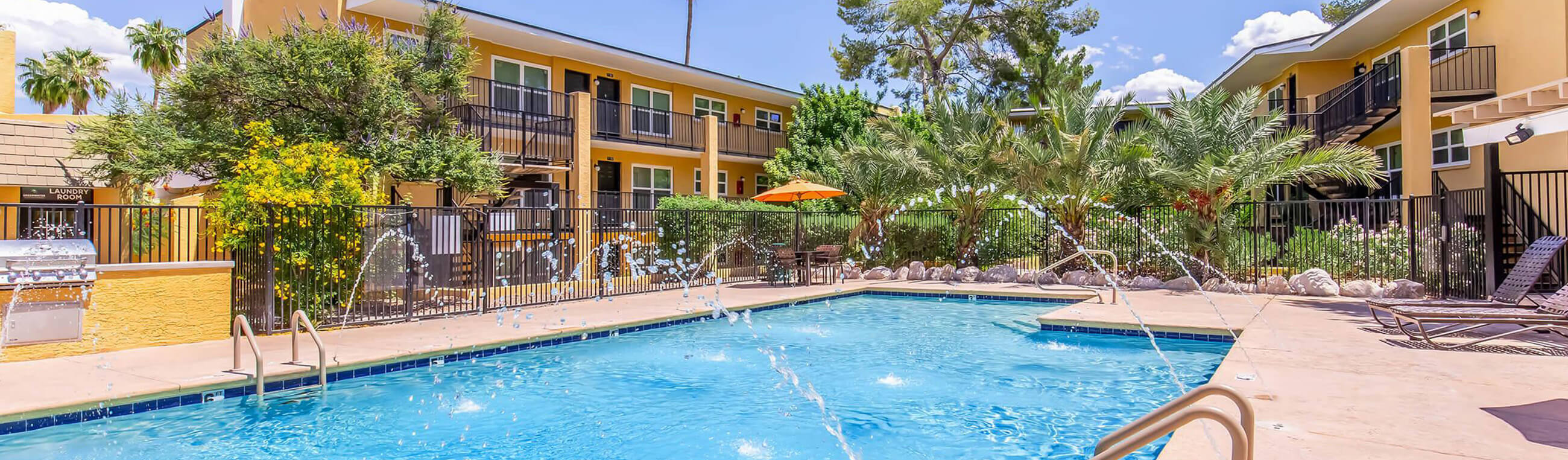 exterior apartment with a pool and fountains